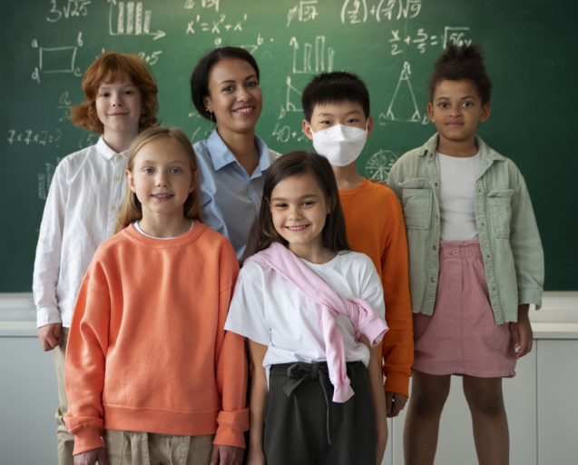Students standing in front of a blackboard