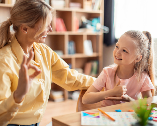 Teacher using sign language with a girl