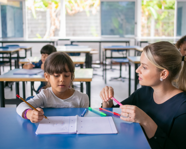 Teacher helping Girl with task
